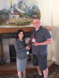 Auburn SD Resource Conservation Manager Scott Weide accepts the EFC Innovations award from NEEC staff member Melanie Danuser